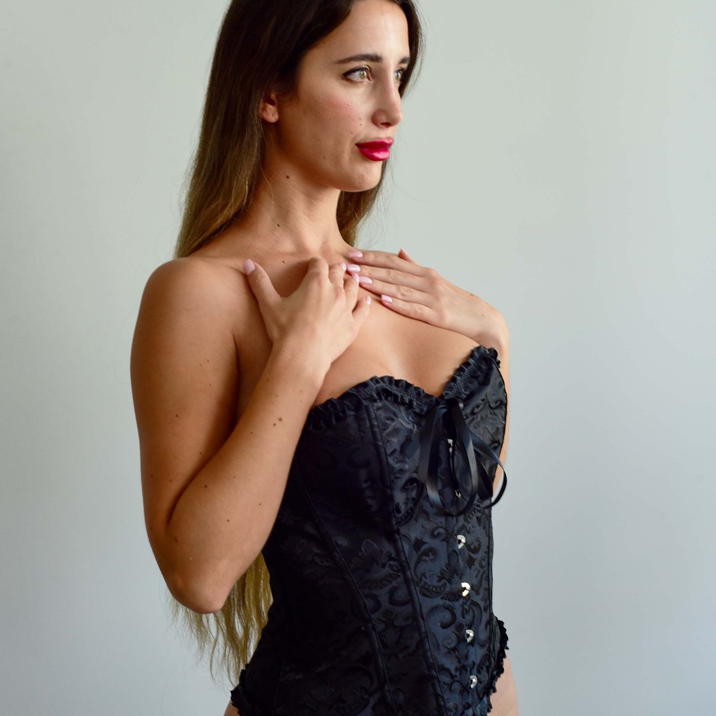 Vintage black corset top with lace-up design and over bust style.
